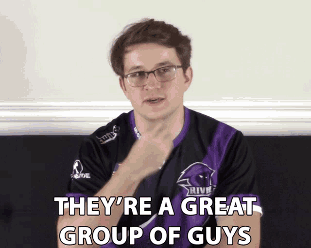 a man with glasses and a purple shirt that says they 're a great group of guys on it