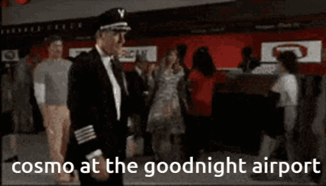 a man in a captain 's hat is standing in front of a crowd and the caption says cosmo at the goodnight airport