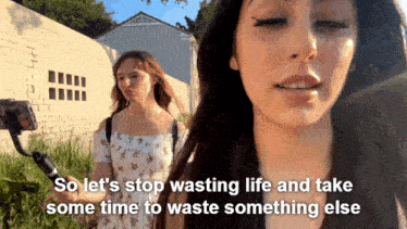 a woman taking a picture of another woman with the words so let 's stop wasting life