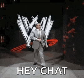 a man in a suit and tie is walking on a stage in front of a w logo .