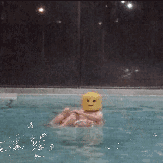 a person in a pool with a lego head
