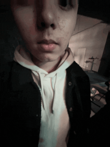 a close up of a person 's face with a hoodie on
