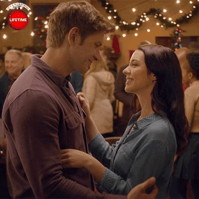 a man and woman are looking into each other 's eyes with a lifetime logo in the background