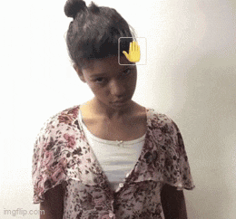 a girl in a floral shirt is making a hand gesture .