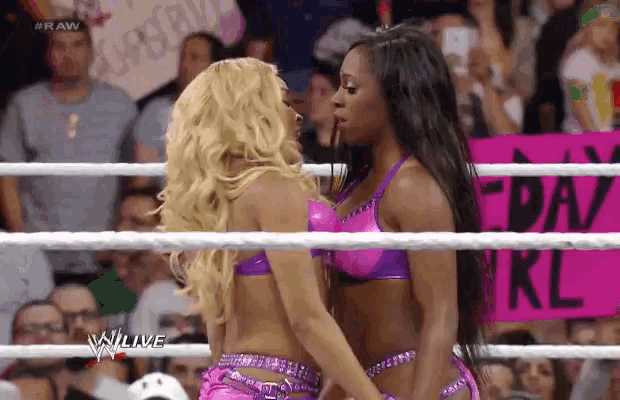 two women wrestling in a ring with a sign that says friday girl on it