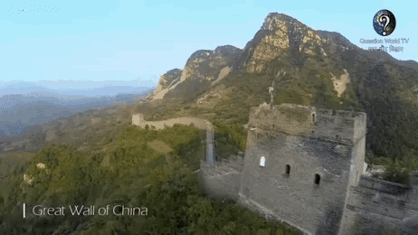an aerial view of the great wall of china with a mountain in the background