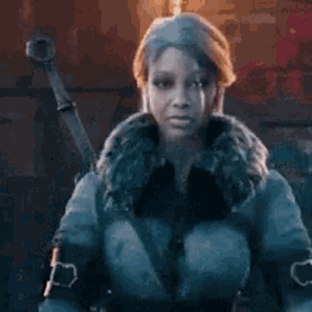 a woman in a fur coat is holding a sword in her hand .