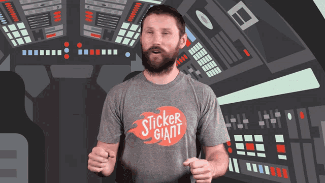 a man wearing a sticker giant shirt stands in front of a control panel