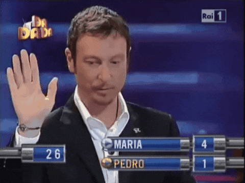 a man in a suit stands in front of a screen with maria and pedro on it