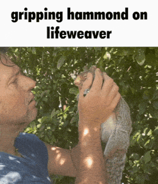 a man is holding a squirrel in his hands and the caption says gripping hammond on lifeweaver