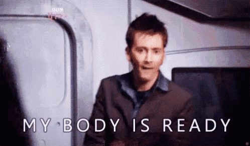 a man in a suit is standing in front of a door with the words `` my body is ready '' .