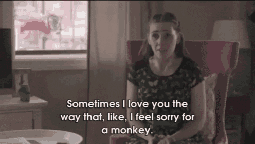 a woman sits in a pink chair and says sometimes i love you the way that