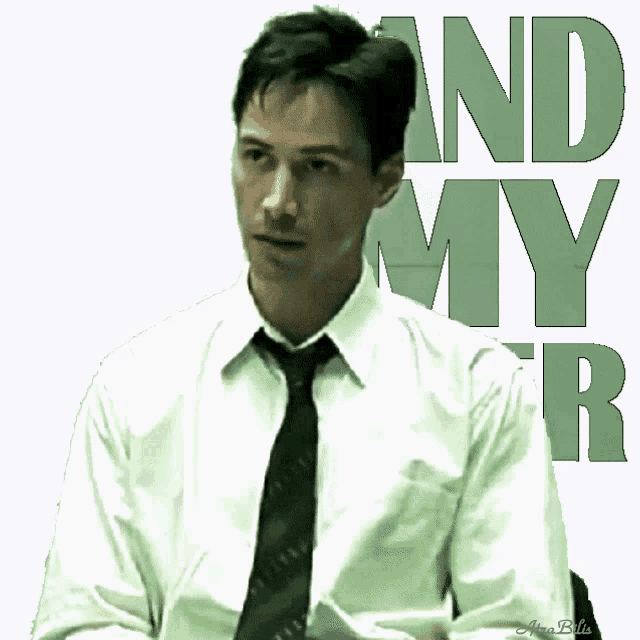 a man in a white shirt and tie is standing in front of a sign that says " and my r "