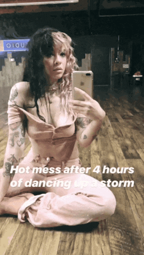 a woman taking a selfie with the words hot mess after 4 hours of dancing up a storm below her
