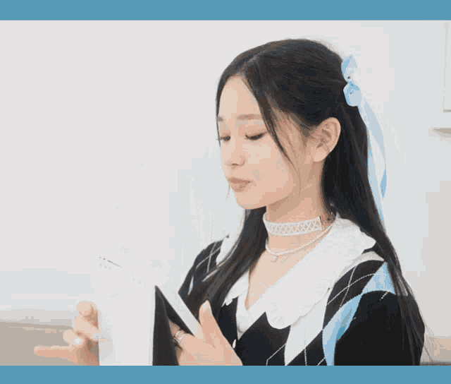a girl is holding a calendar that says 20 on it