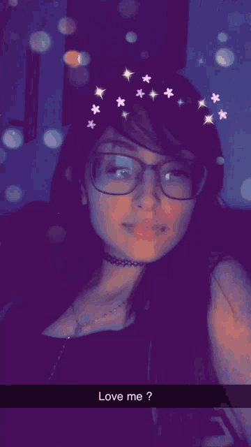 a girl with glasses and a choker says love me on the bottom