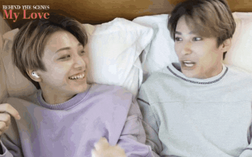 two young men laying on a bed with the words behind the scenes my love on the bottom