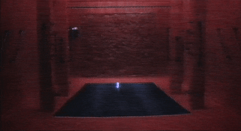 a dark room with a blue light coming out of the corner of the room .
