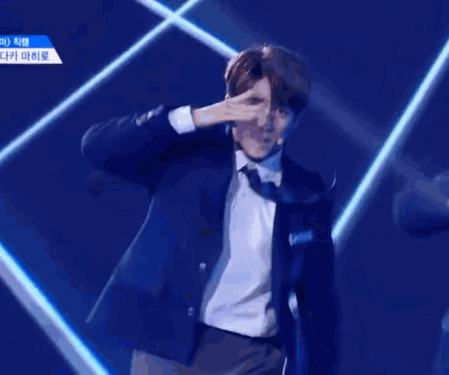 a man in a suit and tie is dancing on a stage and his name is james