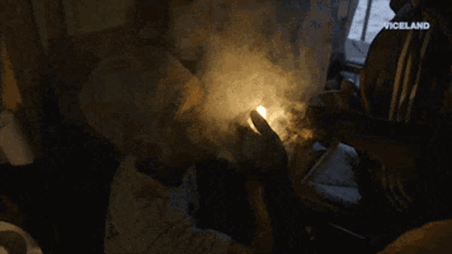a person lighting a candle with the word vigilante visible