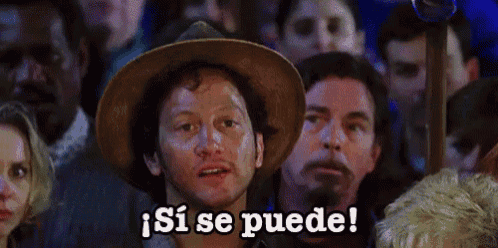 a man in a cowboy hat is surrounded by a crowd and says si se puede