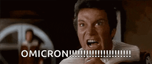 a man is screaming with his mouth open and the words omicron written on the screen .
