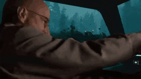 a man is holding a gun in a video game while driving a car in a forest .