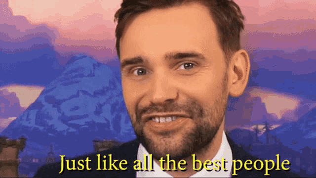 a man with a beard is smiling with the words just like all the best people behind him