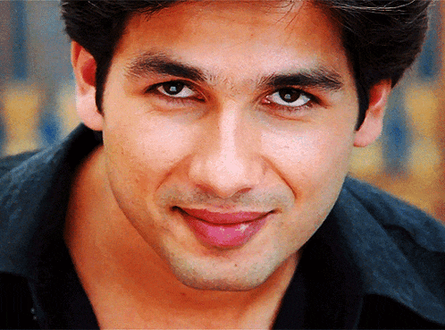 a close up of a man 's face with a black shirt