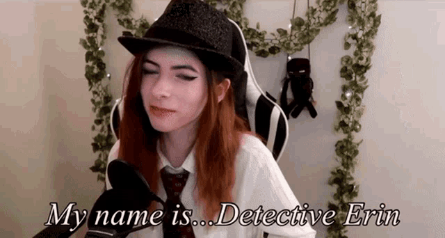 a woman wearing a hat and tie is talking into a microphone and says my name is detective erin