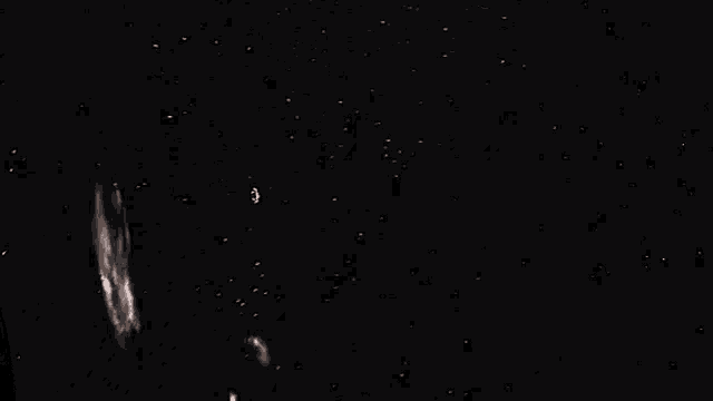 a spaceship is flying through a galaxy in the night sky .