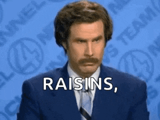 ron burgundy is wearing a suit and tie and says `` raisins '' .