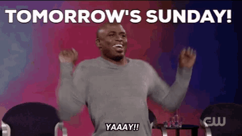 a man is sitting on a stage with his arms in the air and says tomorrow 's sunday .