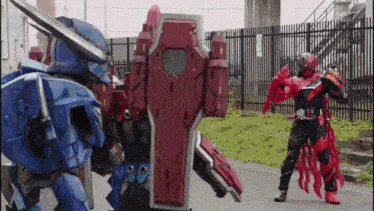 a man in a robot costume is standing in front of a robot .