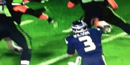 a football player with the number 3 on his jersey is being tackled