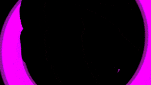 a man in a suit and tie stands in front of a purple swirl