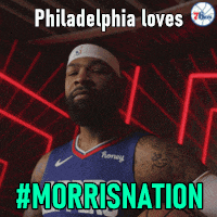 a man in a philadelphia jersey is flexing his muscles with the caption # morrisnation