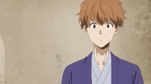 a man in a kimono with his eyes closed is standing in front of a wall with his eyes closed .