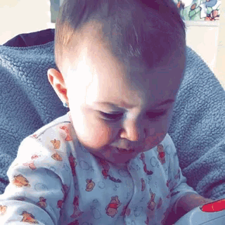 a baby wearing a winnie the pooh outfit is sitting in a chair