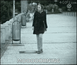 a black and white photo of a woman walking down a sidewalk with the words mooooorning written below her .