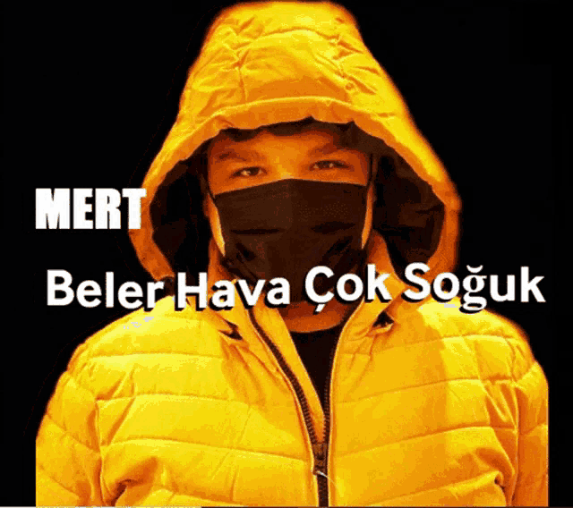 a man wearing a yellow jacket and a black face mask