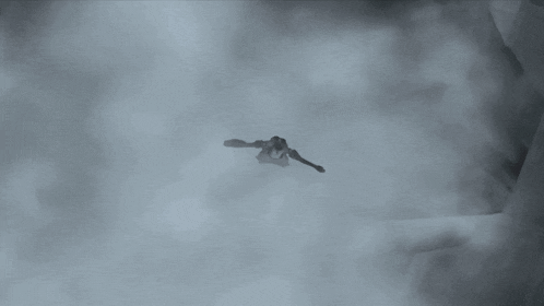 a person is flying through the air in a dark room