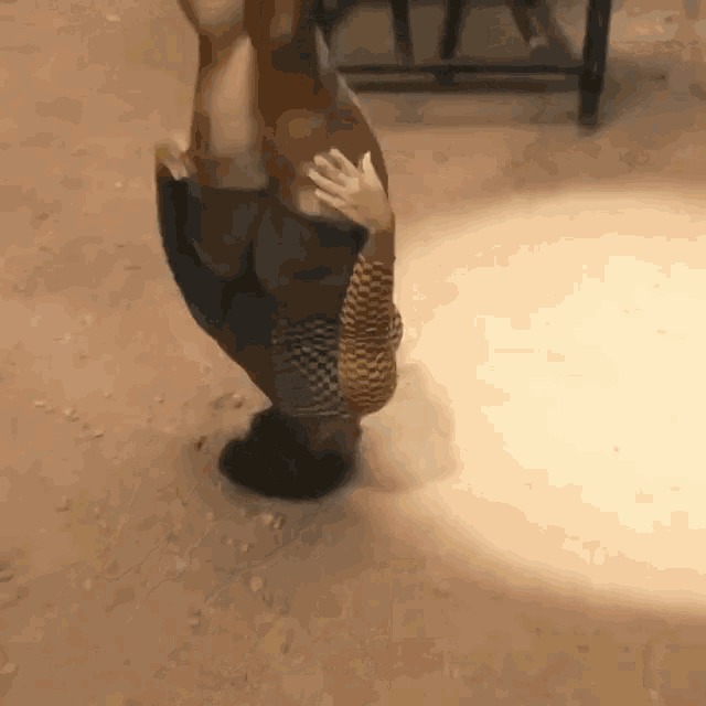 a person is holding another person 's hand while standing on the ground .
