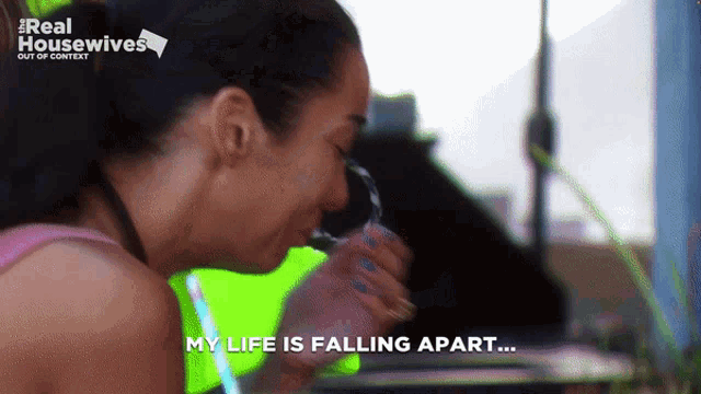 a woman says " my life is falling apart " in front of a real housewives logo