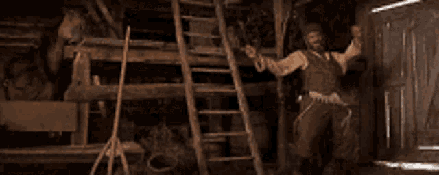 a man is standing in a barn with his arms in the air
