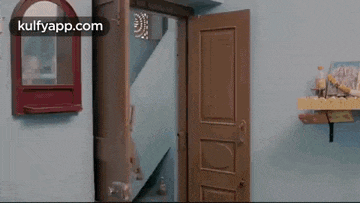 a door is open in a room with a mirror on the wall .