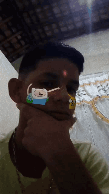 a young man with a cartoon character on his face