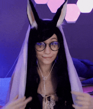 a woman wearing a bunny costume and glasses has a scarf around her head