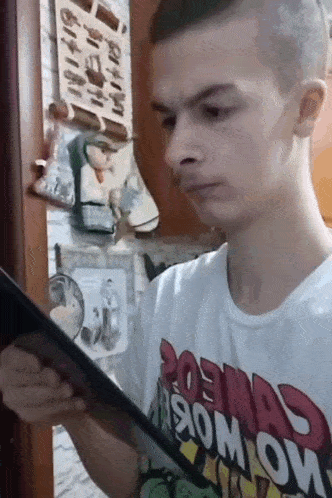 a man wearing a t-shirt that says cosmos on it