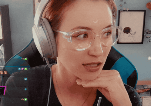 a woman wearing glasses and headphones is looking at something